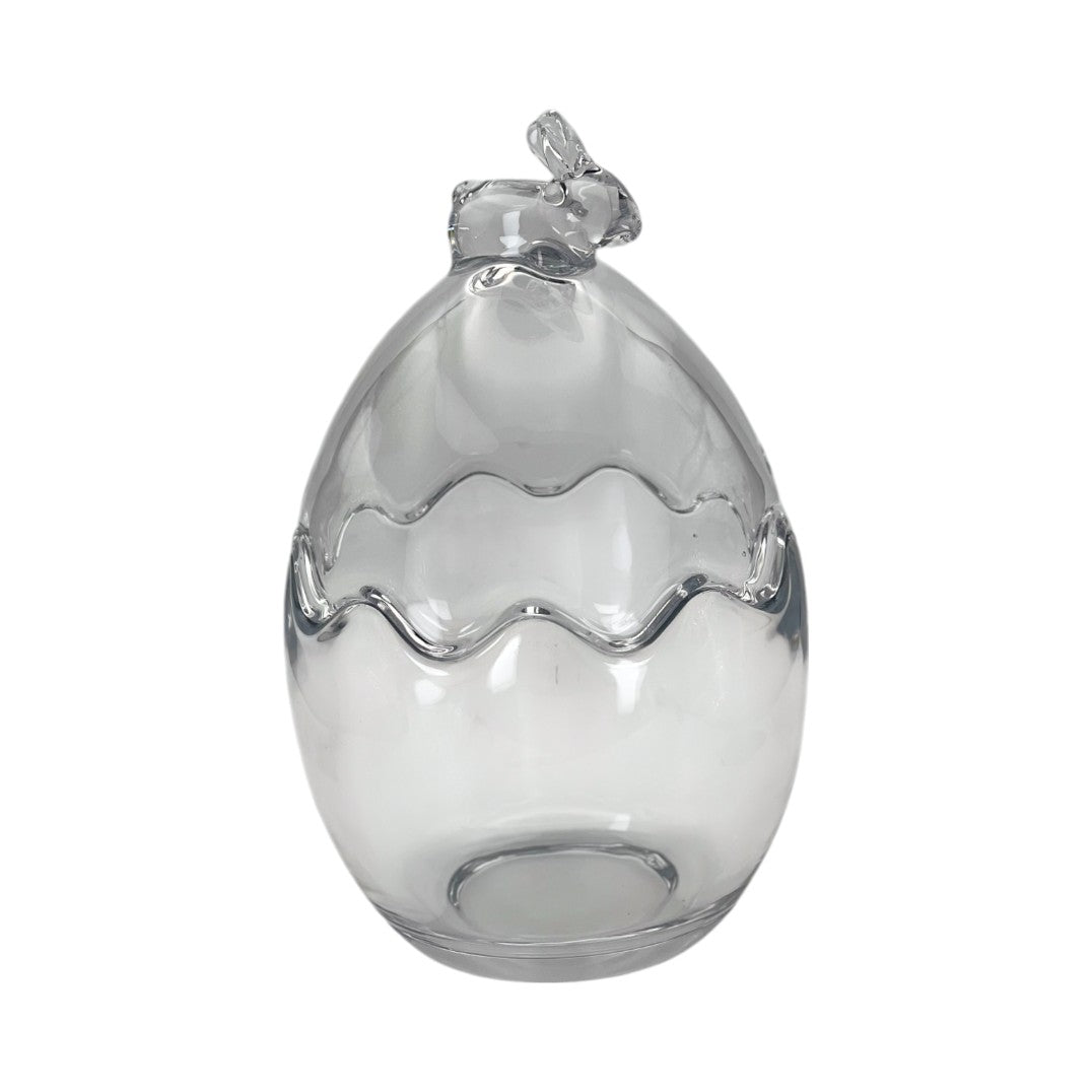 Œuf décoratif en verre transparent orné d’un petit nœud en haut. Parfait pour une décoration de Pâques chic et moderne. Peut être utilisé en centre de table ou vitrine.