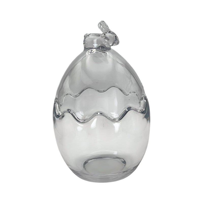 Œuf décoratif en verre transparent orné d’un petit nœud en haut. Parfait pour une décoration de Pâques chic et moderne. Peut être utilisé en centre de table ou vitrine.